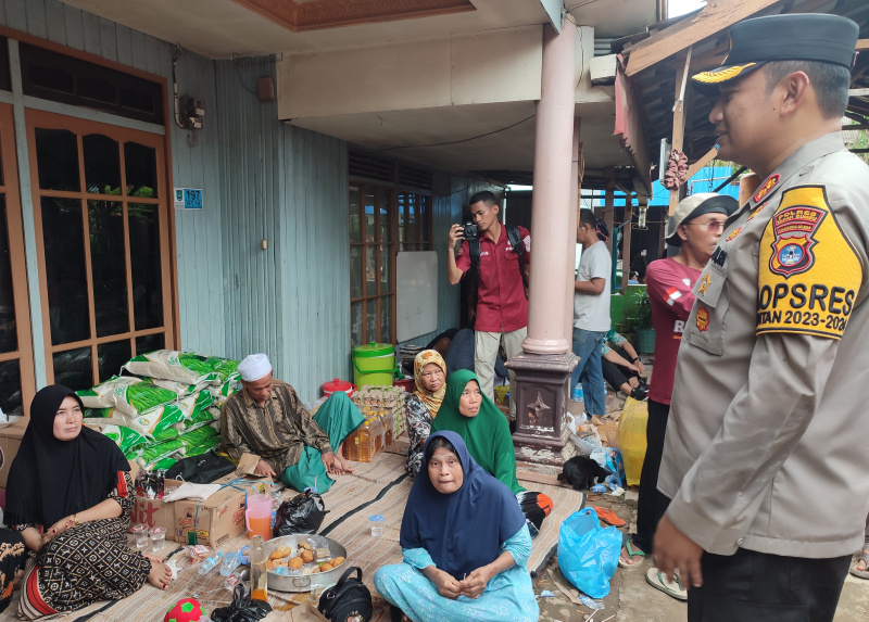 (Foto : Man Hidayat/metrokalsel.co.id) Kapolres Tanah Bumbu AKBP Arief Prasetya SIK saat berbincang dengan warga korban banjir yang terlihat masih trauma dengan peristiwa kebakaran tersebut, Selasa (6/2/24) 